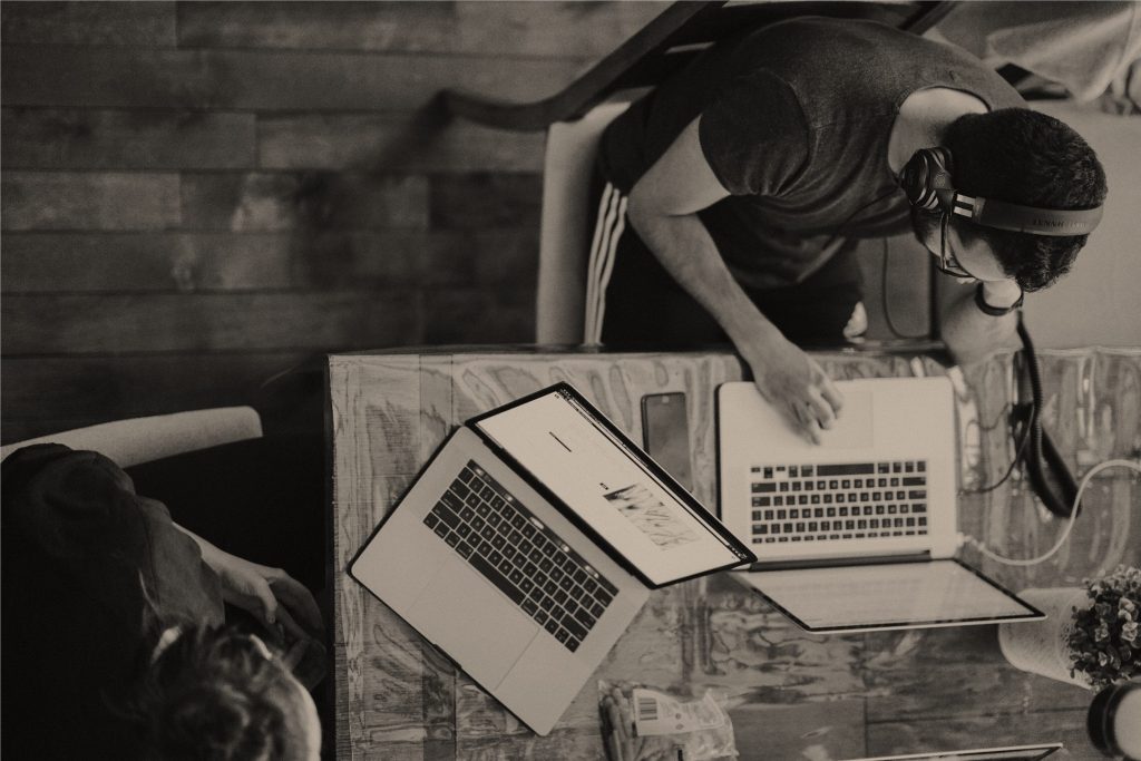 Two men working on their laptops